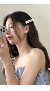 Close-up of pearl flower jewelry set featuring elegant ring and stud earrings on model