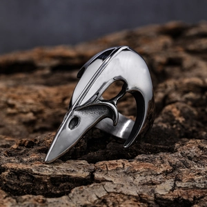 Gothic raven skull stainless steel ring in vintage silver finish on natural bark texture