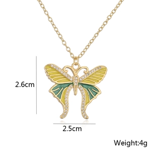 Detailed view of candy-colored enamel butterfly pendant with 18K gold and zircon inlay