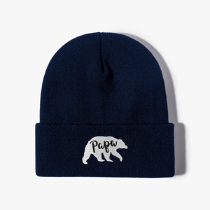 Detailed close-up of polar bear embroidery and Papa text on navy knit beanie hat