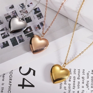Three polished stainless steel heart photo locket necklaces in silver, gold and rose gold