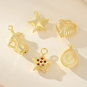 Golden DIY jewelry pendant set with star, heart, and teardrop shapes for necklaces