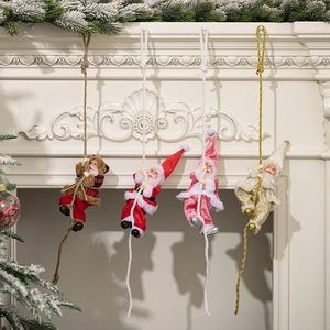Set of four Santa Claus pendants in red, pink, gold and plaid on a white fireplace
