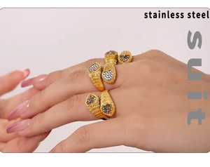 Detailed view of three stainless steel snake rings with colorful zircon inlay on model