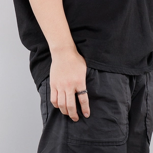 Detail shot of a men's vintage razor blade style ring in dark grey titanium steel