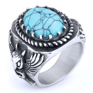 Detail of vintage eagle relief and turquoise gemstone on bicolor men's ring