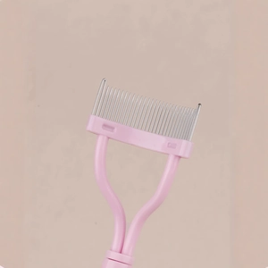 Pink folding eyelash comb with fine steel teeth for mascara grooming and shaping
