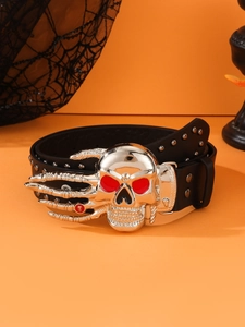 Detail of punk leather belt with silver skull buckle and metal rivets on orange background