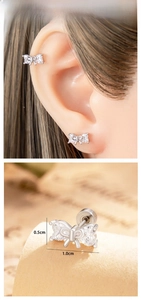 Macro detail of silver bow stud earrings with heart crystals and dimensions