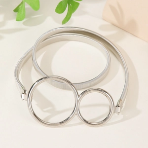 Silver spring metal belt with double ring buckle on a minimalist beige background
