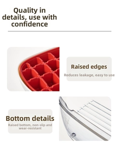 Detail of red ice cube tray with raised edges and non-slip bottom for easy release