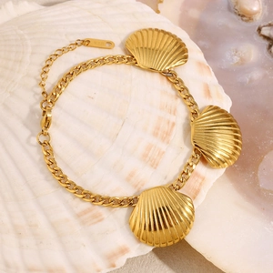 Detail of 18K gold plated shell charm bracelet showing K18 stamp on adjustable chain
