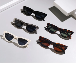 Five pairs of cat-eye sunglasses in black, white, grey and tortoiseshell colors