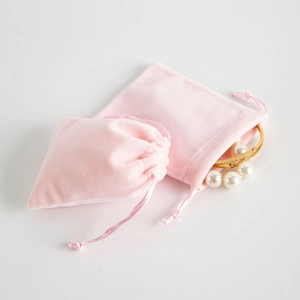 Detail of light pink velvet drawstring jewelry pouches for elegant accessory storage