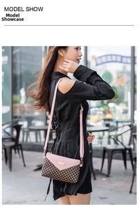 Pink and brown polka dot crossbody bag with V-shaped flap and gold hardware detail