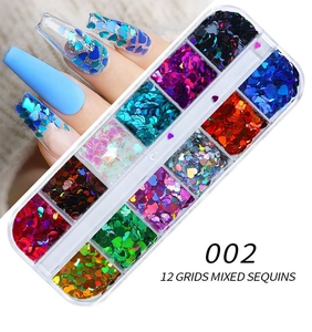 Macro detail of 12-grid heart nail glitter set with mixed colorful laser sequins