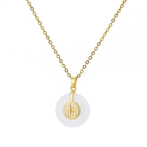 Macro detail of gold clover necklace with white jade pendant and Fu character charm