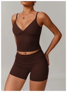 Detail of slim strap deep V-neck chocolate brown sports bra and high waist cycling shorts