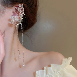 Detail showing crystal flower butterfly ear cuff with long silver tassels on model