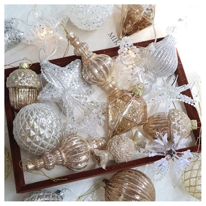 Detailed macro view of assorted champagne gold and silver Christmas tree ornament set