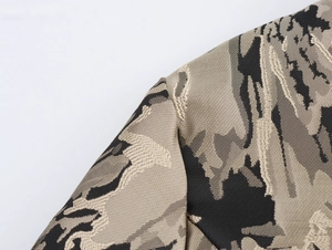 Close-up of beige and grey camo jacquard fabric texture with detailed stitching lines