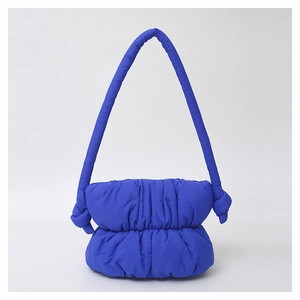 Detail of blue padded nylon shoulder bag with soft pleated cloud design and wide strap