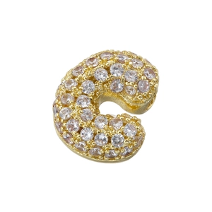 Macro shot of 5A cubic zirconia stones set in a gold letter C jewelry pendant