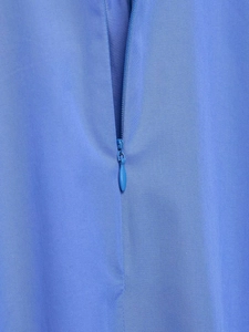 Détail de la chemise en popeline bleu ciel avec texture sergé et fermeture éclair invisible