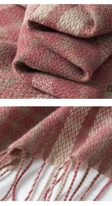 Detail of pink and beige plaid scarf showing soft woven texture and fringe edges