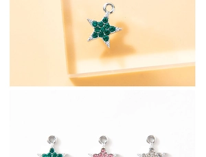 Macro detail of star-shaped pendants with colorful crystals in green, pink and clear