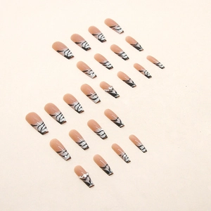Long trapezoid press-on nails with nude base, black zebra patterns and silver rhinestones