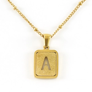 Detail of 18K gold letter A pendant with sandblasted texture on a beaded chain