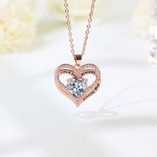 Detail of rose gold heart pendant with I love you always and forever engraving and crystals