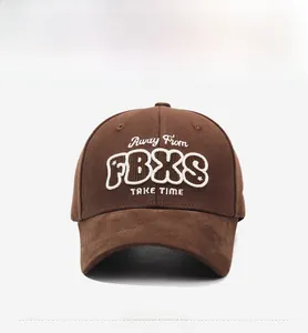 Detail of dark brown cotton baseball cap showing white 3D embroidery and durable fabric texture