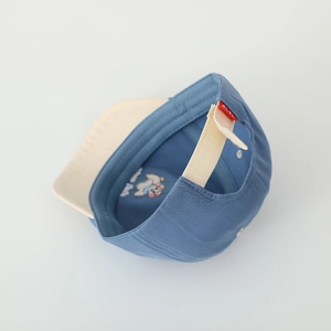 Detail view of cotton toddler baseball cap with cartoon embroidery and adjustable strap