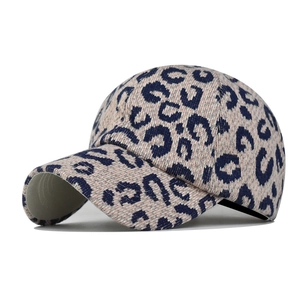 Detail view of pink leopard print baseball cap with thick textured knit fabric texture