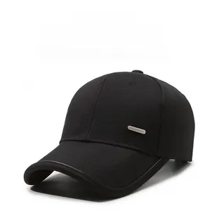 Detailed macro view of the metal decorative plate with Fashion text on a black cotton baseball cap