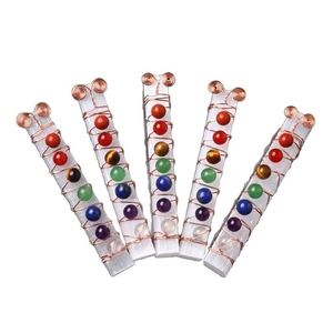 Natural selenite crystal wand wrapped in copper wire with seven chakra gemstones