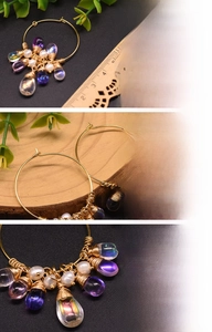 Detailed view of handmade earrings with freshwater pearls and 18K gold plated wire wrapping