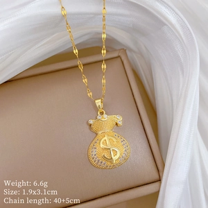 Close-up of gold money bag necklace with dollar sign and rhinestones on a jewelry box