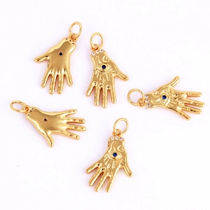 Detailed view of five golden Hamsa Hand charms with blue Evil Eye rhinestones