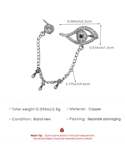 Detailed view of evil eye cuff earring with chain and teardrop charm in silver copper