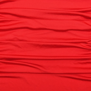 Detailed close-up of vibrant red pleated mesh fabric texture and draped material finish
