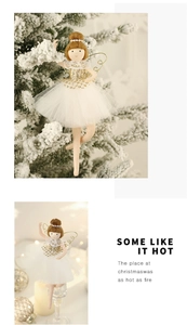 Close-up of ballet angel Christmas ornament with white sequin tutu and gold wings on a tree
