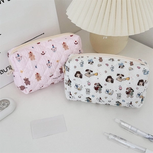 Detail of cute quilted cotton stationery bags with floral bear patterns and zipper closure