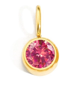 Macro shot of a pink birthstone pendant with round cut and polished gold metal frame