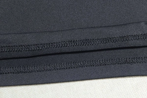Detail of the high-quality double-needle stitching and smooth black jersey fabric texture