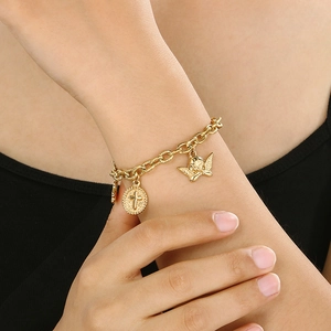 Detailed view of vintage 18K gold plated chunky chain bracelet with cross and angel charms