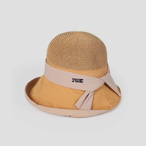Close-up detail of an elegant women's sun hat with straw crown and mustard brim