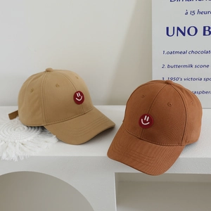 Kids baseball caps in khaki and warm brown with red smile patch and cotton twill fabric